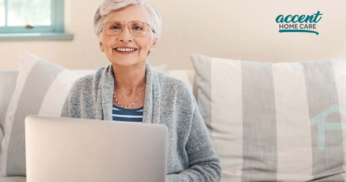 Lady smiling sitting in her home, on her laptop.  