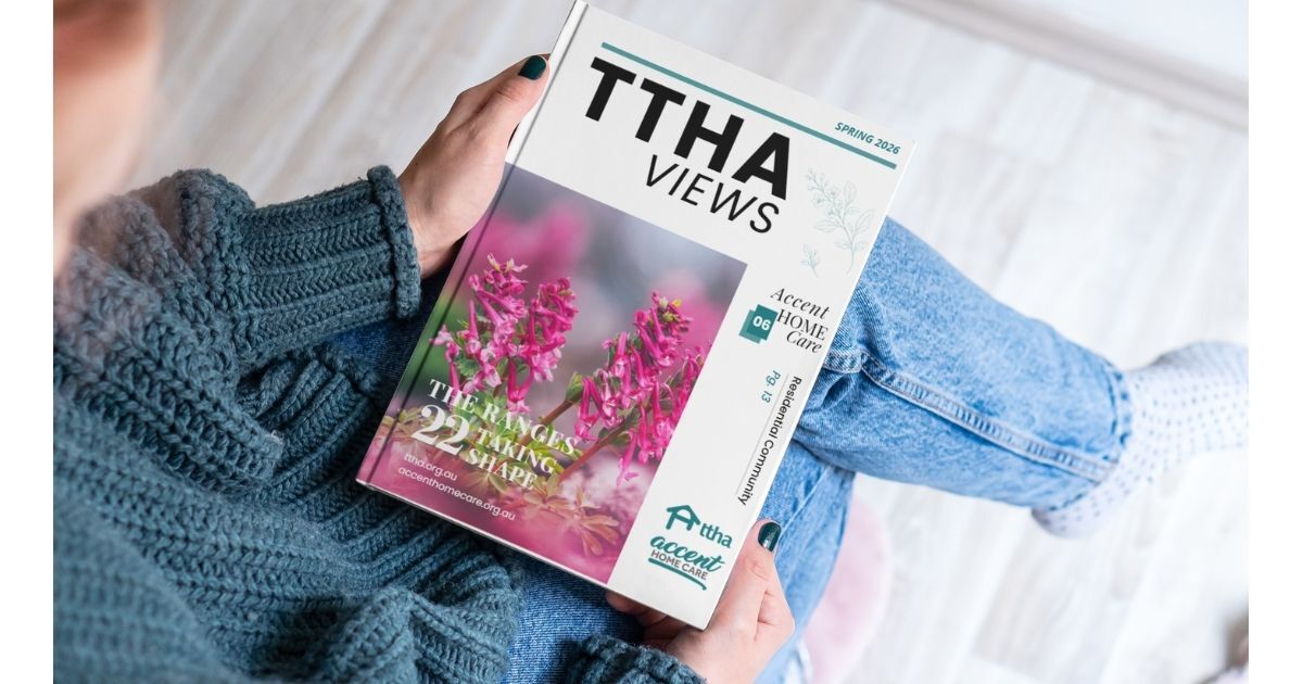 person holding the spring 2026 edition of the TTHA Views community magazine.